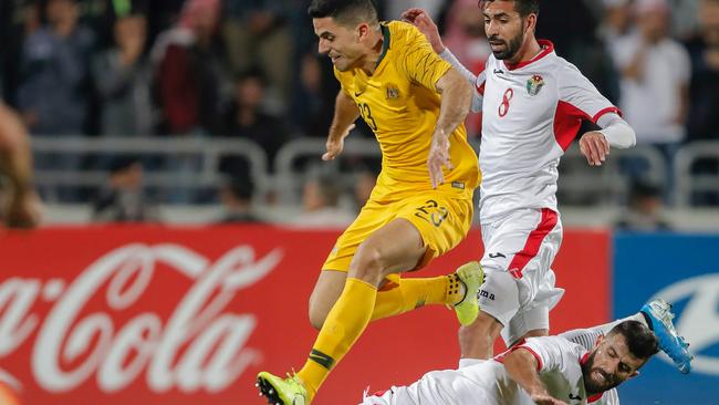 Australia's midfielder Tom Rogic dribbles the ball over Jordan's midfielder Baha Abdel-Rahman during the Socceroos’ 1-0 win over Jordan. Picture: AFP