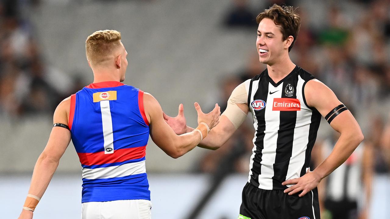 Adam Treloar shakes hands with Tyler Brown of the Magpies at the start of the match (Photo by Quinn Rooney/Getty Images).