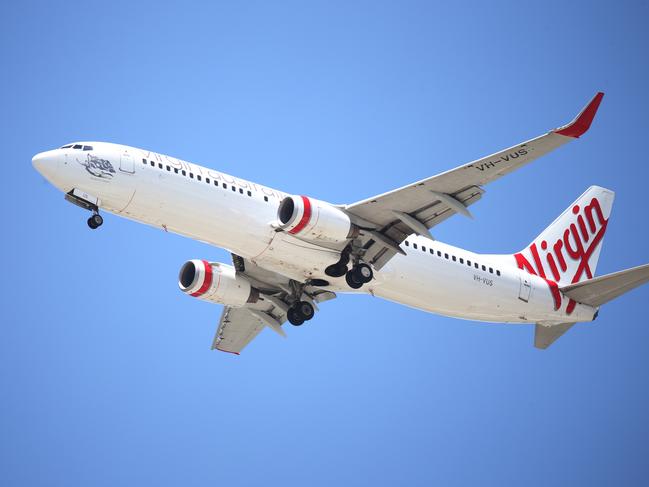 A Virgin Australia passenger jet plane comes into land at the Cairns Airport in Far North Queensland. Picture: Brendan Radke