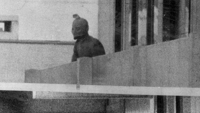 A member of the Palestinian Black September terrorist group takes control of the Israeli compound of the athletes’ village at the Munich Olympics