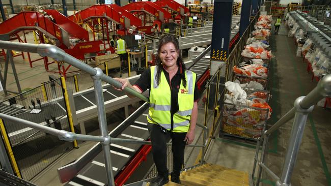 Merima Mahmic, night-shift manager at Australia Post’s Alexandria depot in Sydney, pictured with new sorting machines to handle the booming surge of parcels. Picture: Britta Campion