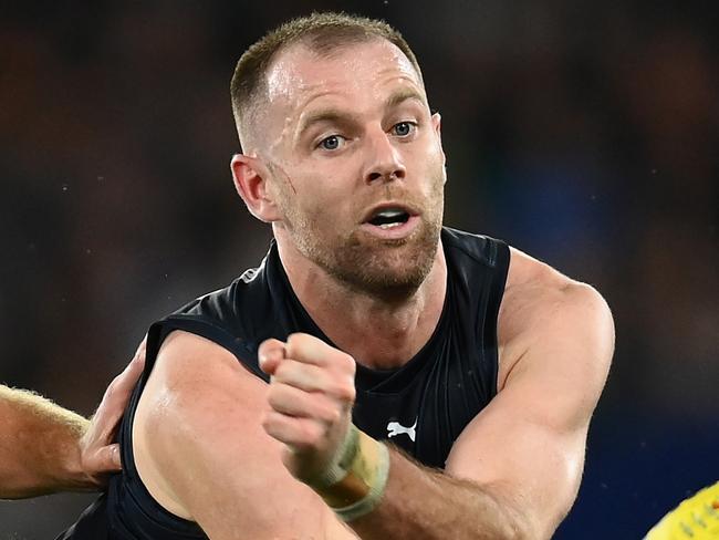 MELBOURNE, AUSTRALIA - APRIL 07: Sam Docherty of the Blues handballs whilst being tackled by Will Phillips of the Kangaroos during the round four AFL match between North Melbourne Kangaroos and Carlton Blues at Marvel Stadium, on April 07, 2023, in Melbourne, Australia. (Photo by Quinn Rooney/Getty Images)