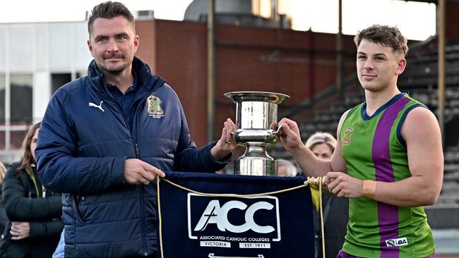 Parade College coach Ricky Dyson and captain Kristian Lawson with the trophy and pennant. Picture: Andy Brownbill