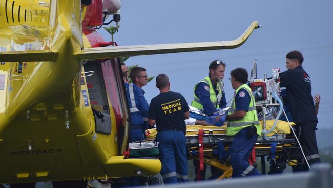 A man who suffered serious injuries after the red sedan Mitsubishi Lancer sedan he was driving crashed into a power pole on Rogans Bridge Rd north of Waterview Heights was transported by road ambulance to the Westpac Rescue Helicopter located in a nearby paddock on Thursday, 18th February, 2021. Photo Bill North / The Daily Examiner