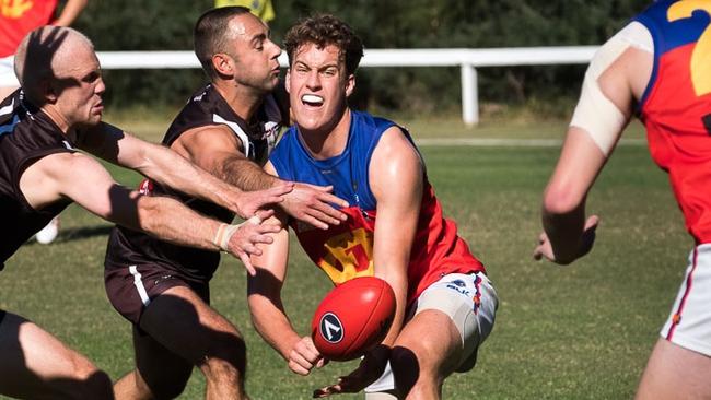 Ted Clayton fires out a handball. Picture: Peter Casamento.