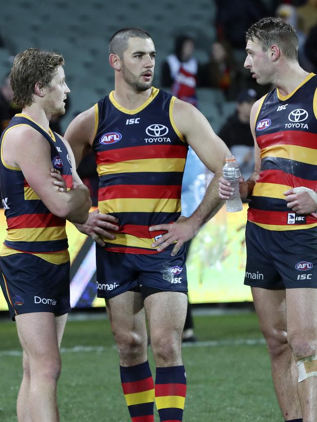 Rory Sloane, Taylor Walker and Daniel Talia in discussion after Saturday’s loss to Melbourne. Picture Sarah Reed