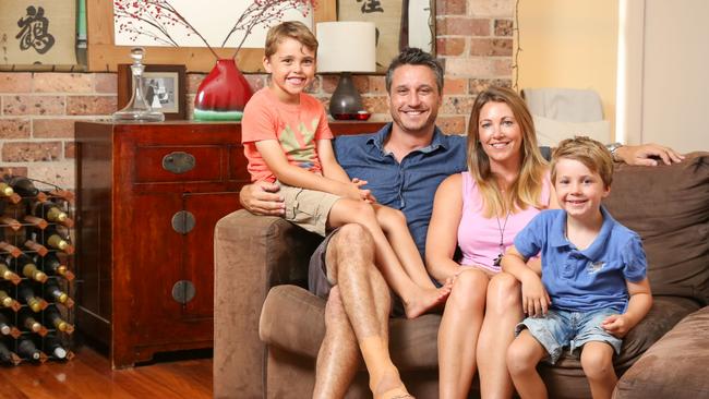 Owen and Katie Burns with their two boys Sam, 7, and Ollie, 5, in their Newcastle rental home. Picture: Ryan Osland