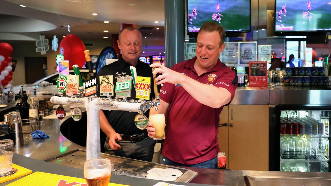 Queensland Premier Steven Miles pours a frothy one under the supervision of Cazalys general manager Jason Wales at Cazalys Sports Club, Cairns, during half time in the 2024 AFL grand final match between the Brisbane Lions and the Sydney Swans. Picture: Brendan Radke