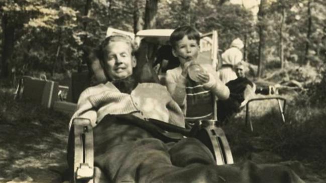 Polio victim and disability campaigner, Robin Cavendish, in his special wheelchair, with his son Jonathan, in 1961.