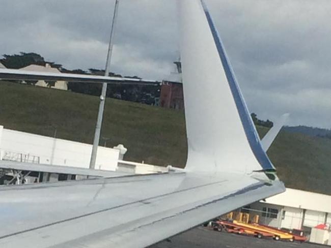 Two planes clip wings at Hobart Airport.