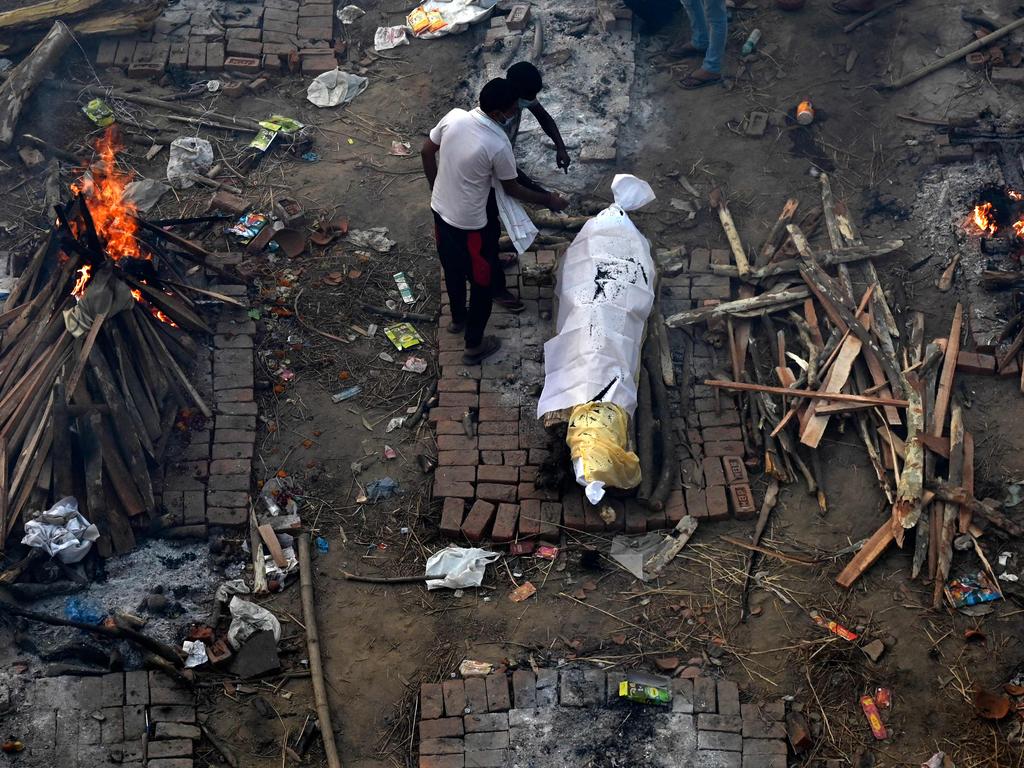 Relatives perform last rites of the victim who died of coronavirus at a cremation ground in New Delhi. The city has extended its lockdown by a week. Picture: AFP