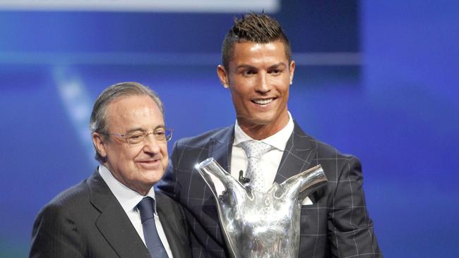 Cristiano Ronaldo of Portugal (R) holds his best European player of the year trophy.