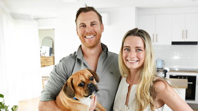 Scott Smith and Michaela Krass are renting a beachside apartment on the Sunshine Coast and leasing out two units they own in the outer Brisbane suburbs. Pictured with their dog Feta. Photo: Patrick Woods.