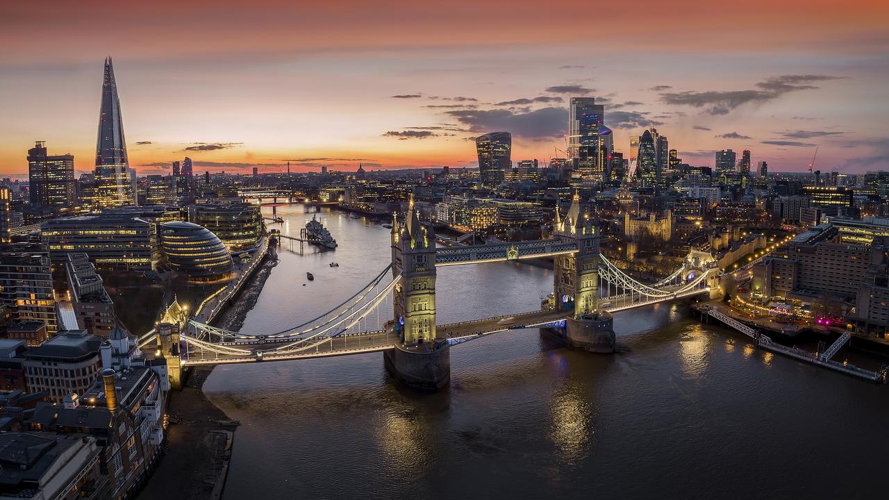 Panoramic, aerial view to the cityscape of London with Tower Bridge and the illuminated skyscrapers of the city during dusk, United Kingdom Photo - Getty Escape 27 Aug 2023 London cover story