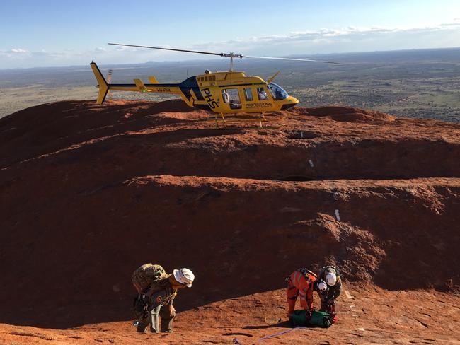 Northern Territory Emergency Service (NTES), along with rangers from Parks Australia and Police from Yulara and Mutitjulu rescued three 22-year-old men after they became stranded in a crevasse at Uluru yesterday. Picture: NTPFES