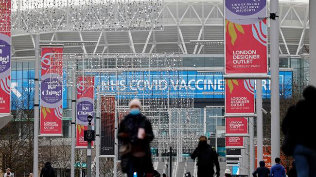 People arrive at the newly-set up Wembley Stadium vaccination centre in London. Picture: AFP.