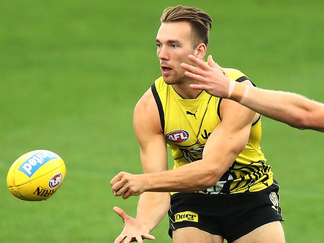 MELBOURNE, AUSTRALIA - MARCH 20: Noah Balta of the Tigers handballs during a Richmond Tigers AFL training session at Punt Road Oval on March 20, 2019 in Melbourne, Australia. (Photo by Michael Dodge/Getty Images)