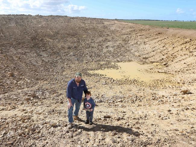 Giffard West farmer Trent Anderson with son Clancy. Picture: Andy Rogers