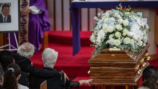 Tony Plati’s 102-year-old mother Maria lovingly touches the casket at his funeral held at St Kevins Catholic Church at Dee Why on March. Picture: Julian Andrews.