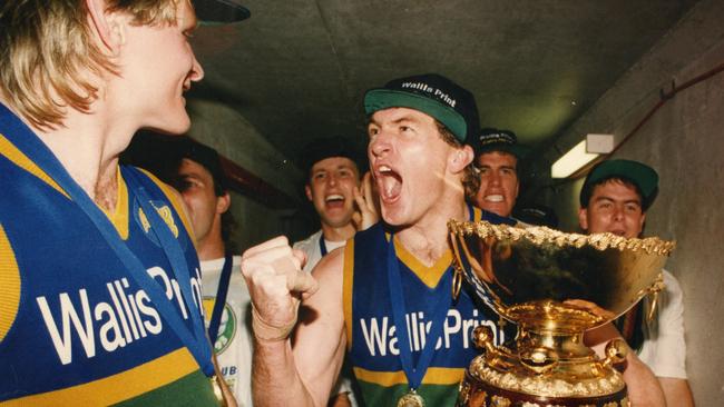 Eagles captain Peter Schwarz celebrates with Andrew Taylor as he holds the Thomas Seymour Hill trophy. Picture: Nicholas Wilson
