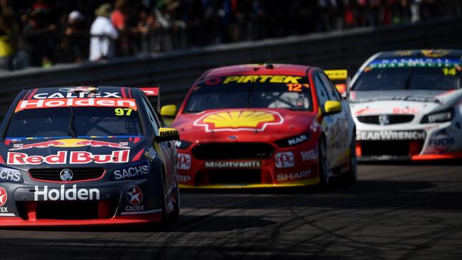 Red Bull Holden driver Shane van Gisbergen in his Holden Commodore VF leads the pack with Shell V-Power driver Fabian Coulthard in his Ford Falcon FG/X and Freighliner driver Tim Slade in his Holden Commodore VF close behind during Sunday's race 12 Virgin Australia V8 Supercars Championship, on the final day of this weekend's Triple Crown V8 Supercars event at the Hidden Valley Speedway in Darwin. Picture: Justin Kennedy