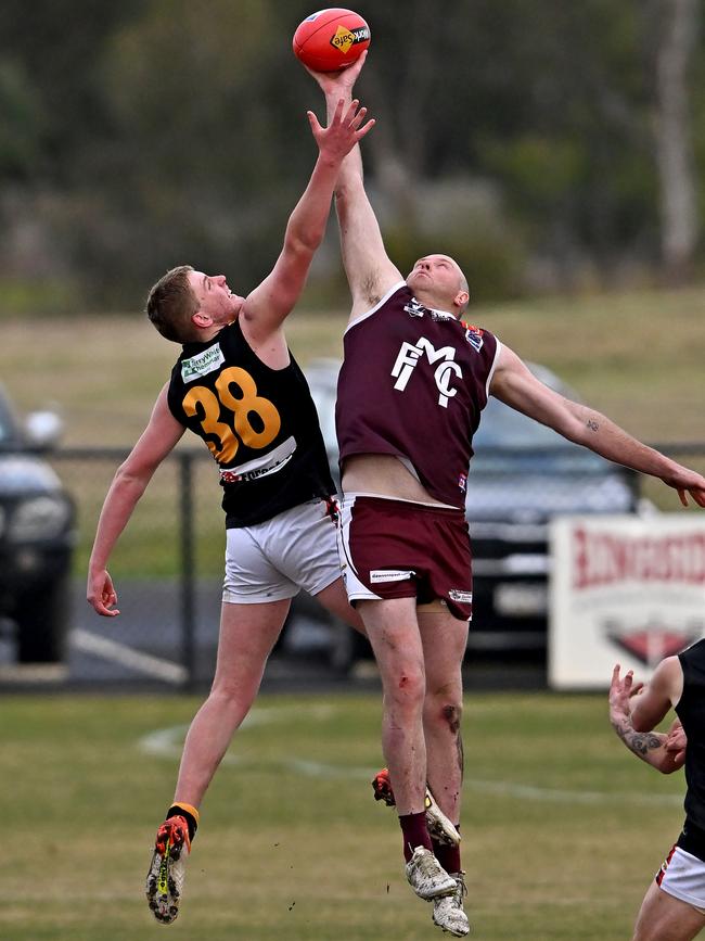 BFL: Bacchus Marsh’s Joel Freeman and Brett McIntyre of Melton jump. Picture: Andy Brownbill