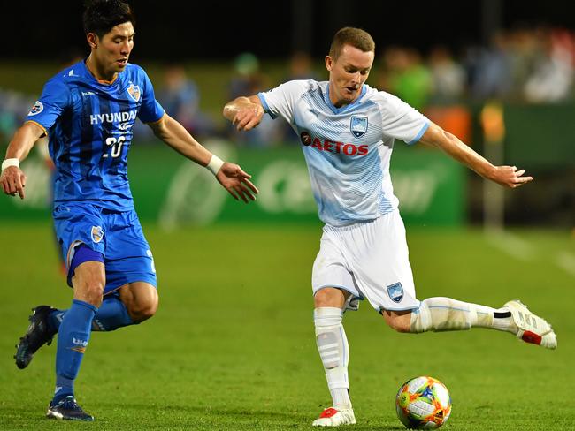 Sydney's Brandon O'Neill plays the ball under pressure from Uslan's Yun Youndson on Wednesday night. Picture: AAP 