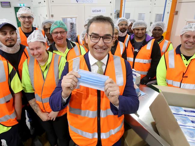 South Australian Premier Stephen Marshall poses for a photo with staff at Detmold Packaging. Detmold is now making PPE equipment. Photo Kelly Barnes