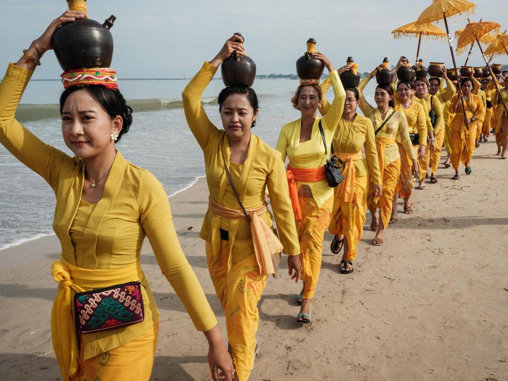 Balinese Hindu women walk on the beach during a ritual a day after Nyepi. It marks the New Year in the Balinese Hindu calendar. Photo taken on March 12, 2024. Picture: Yasuyoshi CHIBA / AFP