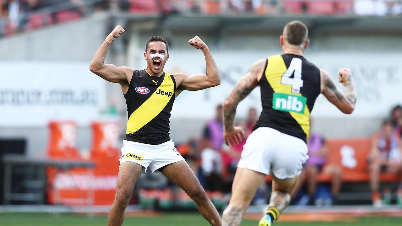 Sydney Stack of the Tigers celebrates kicking his first AFL goal.