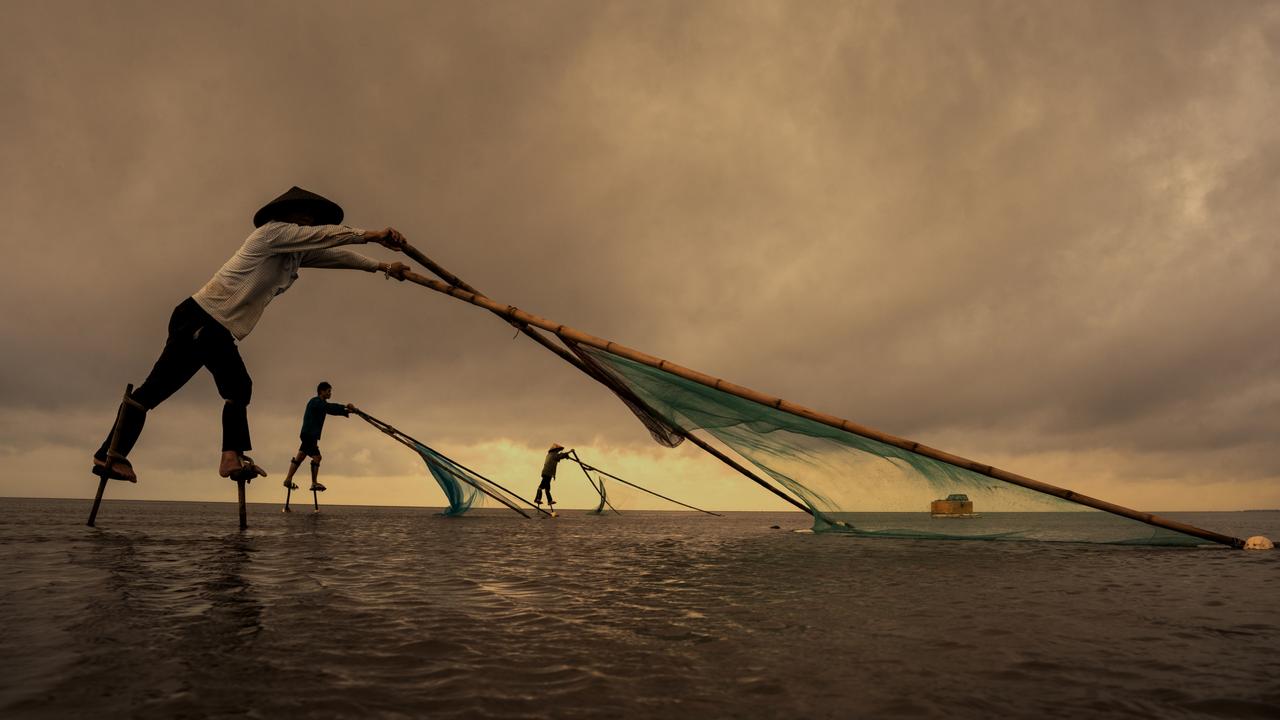 In Vietnam’s vast sea, fishermen on slender stilts cast nets with practised precision. Against the horizon, they move in harmony with the waves, a tradition passed down through generations. Picture: Arun Saha/Pink Lady® Food Photographer of the Year