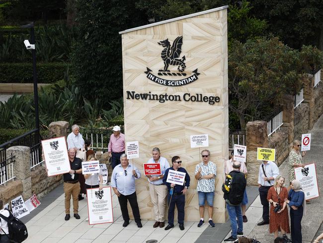 Parents and old boys opposing the Newington College’s switch to becoming a co-ed school staged a silent protest on day one of the 2024 school year. Picture: Richard Dobson
