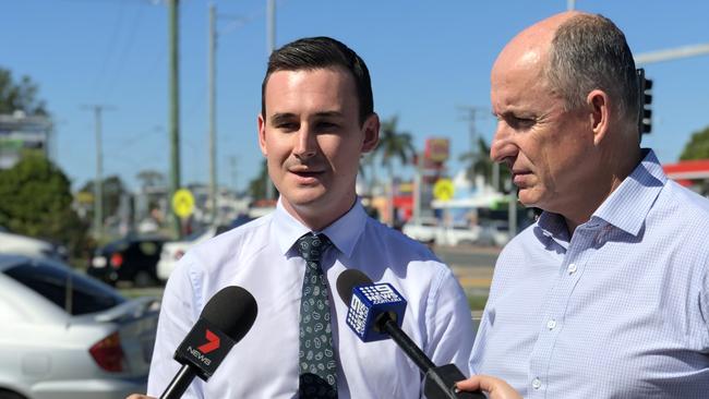 Sam O'Connor and Stuart Robert speak to media at the problem intersection yesterday.