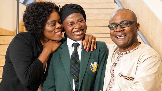 Matala, 17, with parents Rehema Kindu, and Abasi Kyemo Walumona at St Columba College in Andrews Farm. Picture: Morgan Sette.