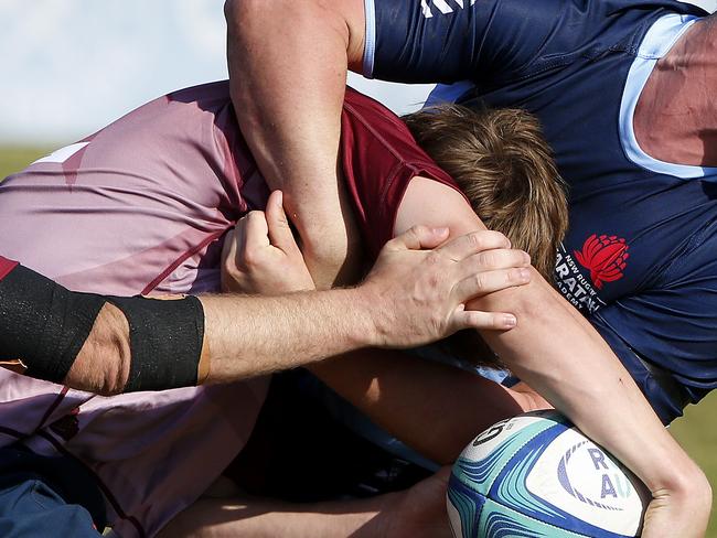 Waratahs' Tom Klem tackles Qld Reds' Jacob Johnson. Junior Rugby Union. Under 18s NSW Waratahs  v Queensland Reds. Picture: John Appleyard