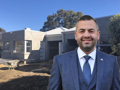 Deputy lord mayor Houssam Abiad (front), with one of his half-built properties (back). Image: Computer generated