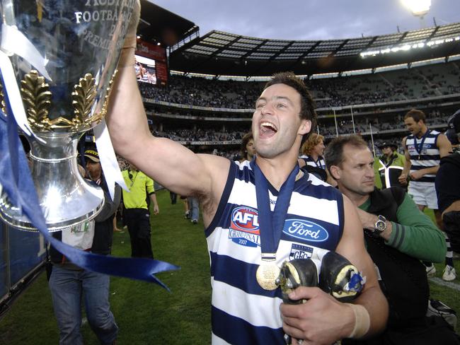 Jimmy Bartel. 2007 Grand Final. Geelong v Port Adelaide. MCG. Brownlow Medal winner Jimmy Bartel with the Premiership Cup. David Caird keeps close.