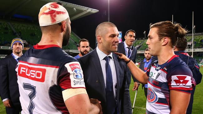 Matt Hodgson of the Force talks with Colby Fainga'a and Ben Meehan of the Rebels.