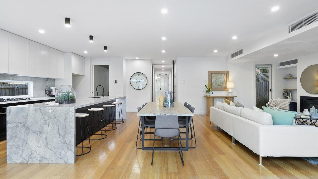 The open-plan kitchen shines with a waterfall island bench, Neff appliances, and a fully equipped butler’s pantry.