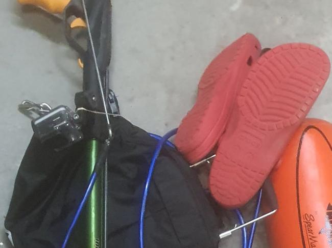 Can you help us identify the suspected owner of this spearfishing gear?, , Officers from South Coast Police District have been told it was recovered from waters about 150m off Narrawallee Beach Headland, Narrawallee, about 3pm today (Tuesday 15 June 2021)., , What was found:, , - A green Typhoon rail gun and spear, - A Go-Pro 4 camera with attached orange Adreno Spear Master buoy, - An Ocean Hunter black fish bag, - A black LED torch, - Blue and red croc-style shoes, , Police have reviewed images on the camera’s SD card and believe the owner of the gear may be a man of Asian appearance, about 20-30 years old and of a slim build., , Please note we have not received any missing persons reports related to this incident at this stage. Picture: Marine Area Command - NSW Police Force