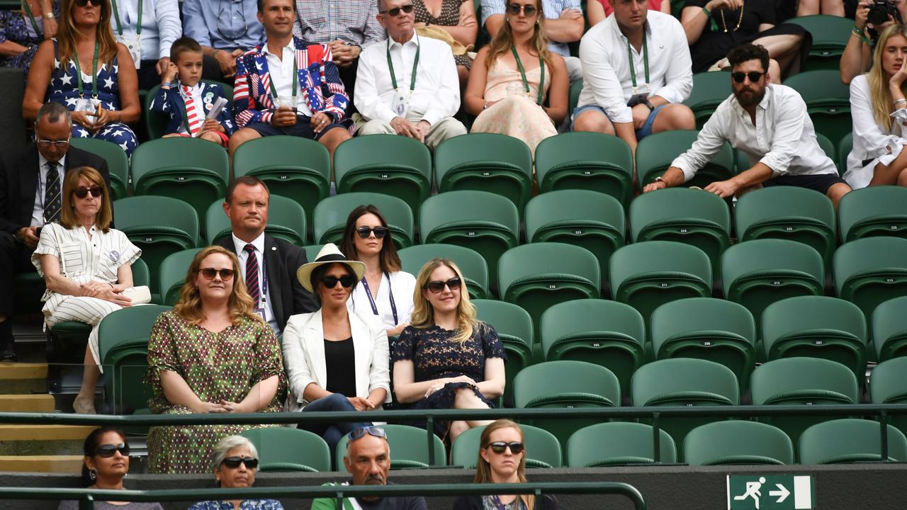 Meghan with friends Genevieve Hillis and Lindsay Roth and a sea of empty seats around them watching the action on Court 1 last week.