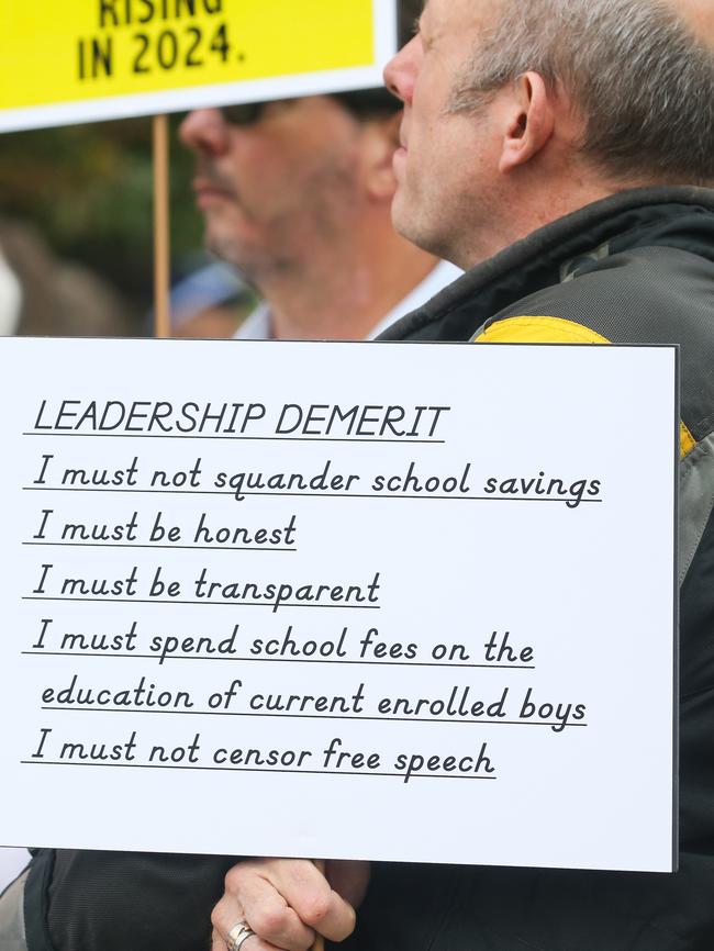 A parent holding one of the signs. Picture: Gaye Gerard