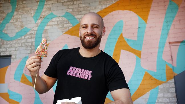 Pictured at Eastern Creek in Sydney is Kerbside Eatery owner Jonathan Israfil with one of his signature products, the 100s and 1000s cheesecake on a stick. Picture: Richard Dobson