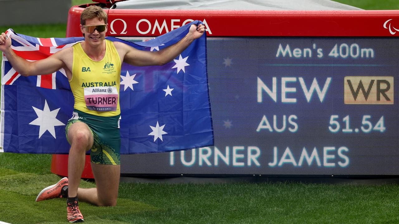 James Turner of Team Australia celebrates with the Australian flag after setting a World Record time of 51:54 during the Men's 400m T36 Final on day six at Stade de France in Paris, France. Picture: Ezra Shaw/Getty Images