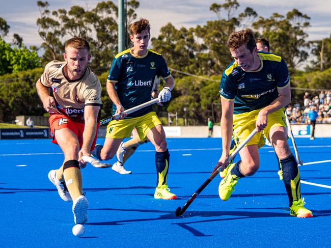 Tassie Tigers players Tim Deavin (left) Lachie Rogers (right) battle for possession. Picture: Liam Boric/Liberty Hockey One League