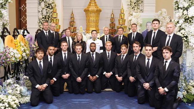 Leicester City players with Aiyawatt Srivaddhanaprabha (C in white uniform), the son of owner Vichai Srivaddhanaprabha while they pay their respect during the second day of the funeral ceremony. Picture: AFP/King Power