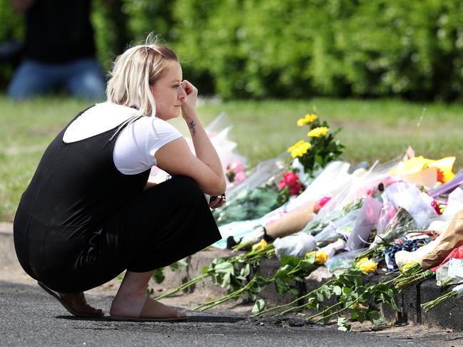 Flowers placed at the murder scene in Camp Hill. Photographer: Liam Kidston