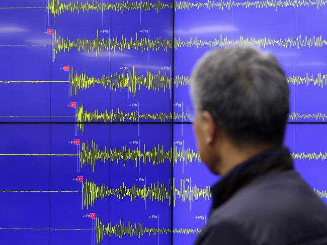 Measuring up ... Yun Won-Tae, an Earthquake and Volcano of the Korea Meteorological Administration Director General stands in front of a screen showing seismic waves that were measured in Seoul, South Korea. Picture: Getty