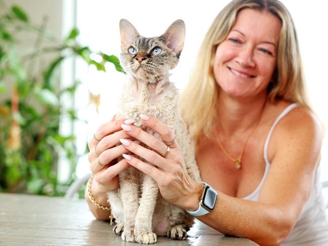 Liz Harris with her cat Gizmo, who was found with the help of a pet detective after she was lost. Picture: Tim Hunter