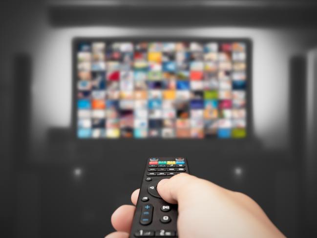 Video on demand, TV streaming, multimedia. Hand holding remote control